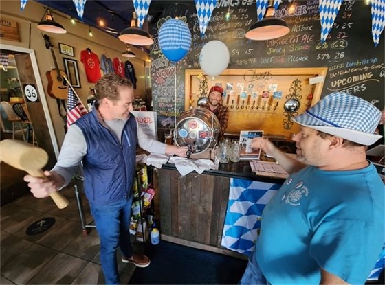 Mayor Perry taps the first keg at Beltoberfest
