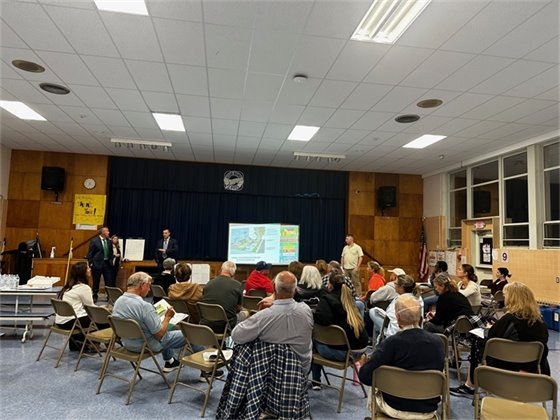 Photo of Deputy Chief Werner and Detective Ric Cruz speaking to the crowd