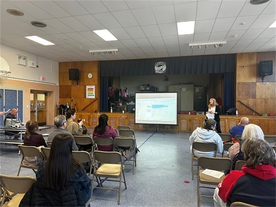 Randi Moore, Chief Executive Officer of the Affordable Housing Alliance, talks to the crowd of community members.