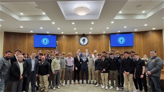 Group photo of Ice Hockey Team and Township Committee