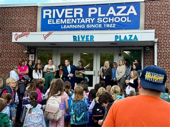 Photo of Mayor Perry speaking in front of the school