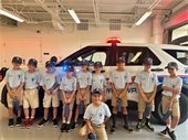 Group photo of campers in front of cop car