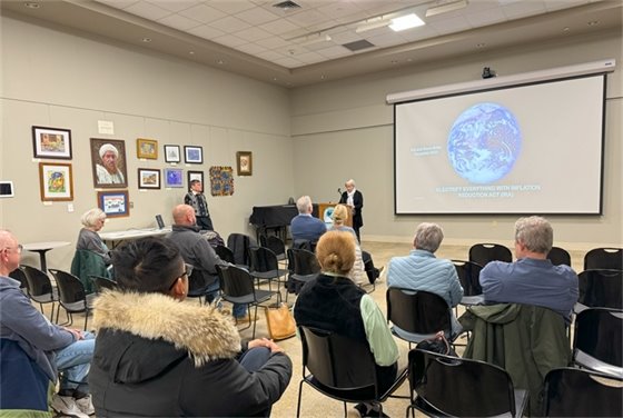 Photo of Pat Miller talking and audience listening